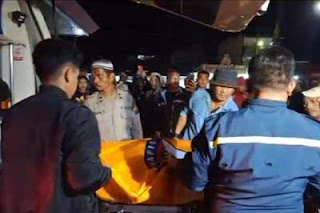 Petugas saat mengevakuasi mayat pria dalam toilet di SPBU Balige, Kabupaten Toba, Sumut.