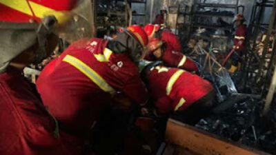 Petugas Damkar Padang mengevakuasi jenazah pemilik ruko