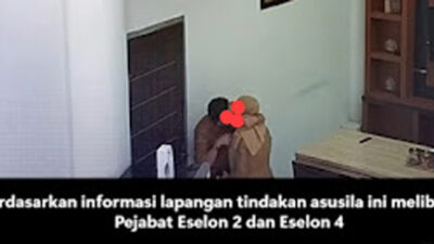Seorang pria dan perempuan mengenakan pakaian dinas diduga sedang bermesraan.